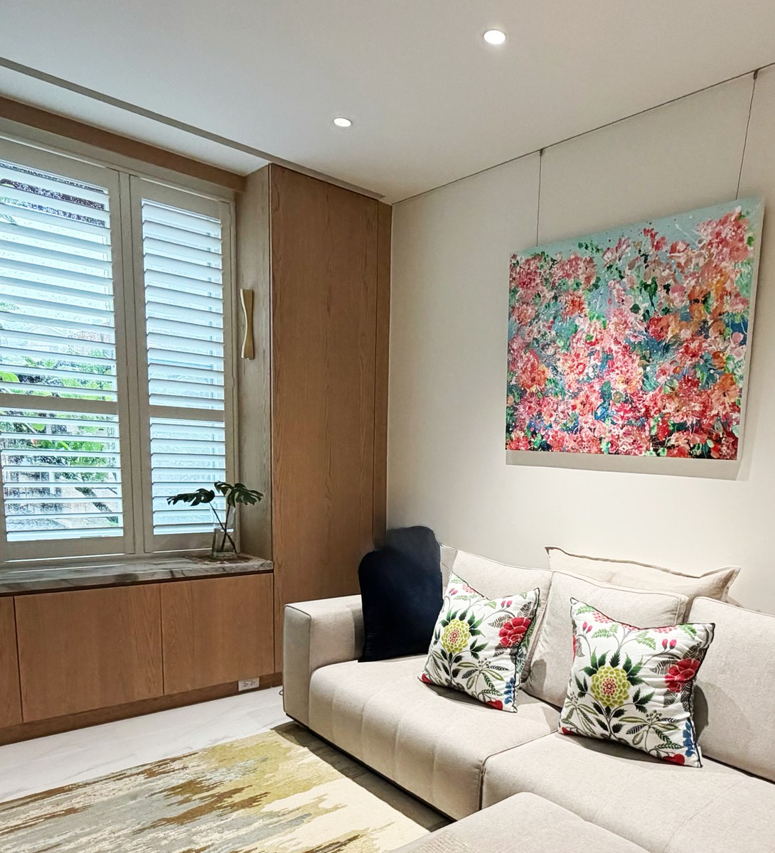 Painting mounted above sofa in collector's living room